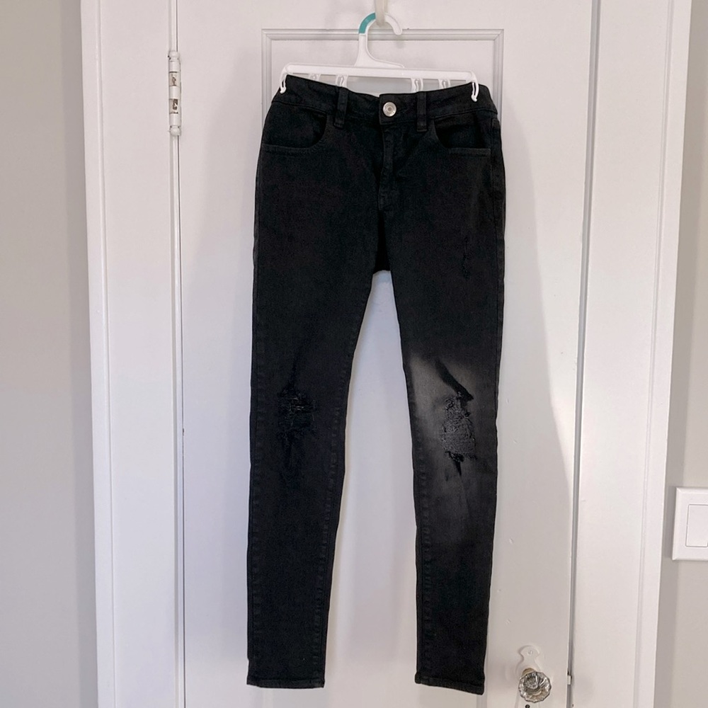 Distressed black skinny jeans